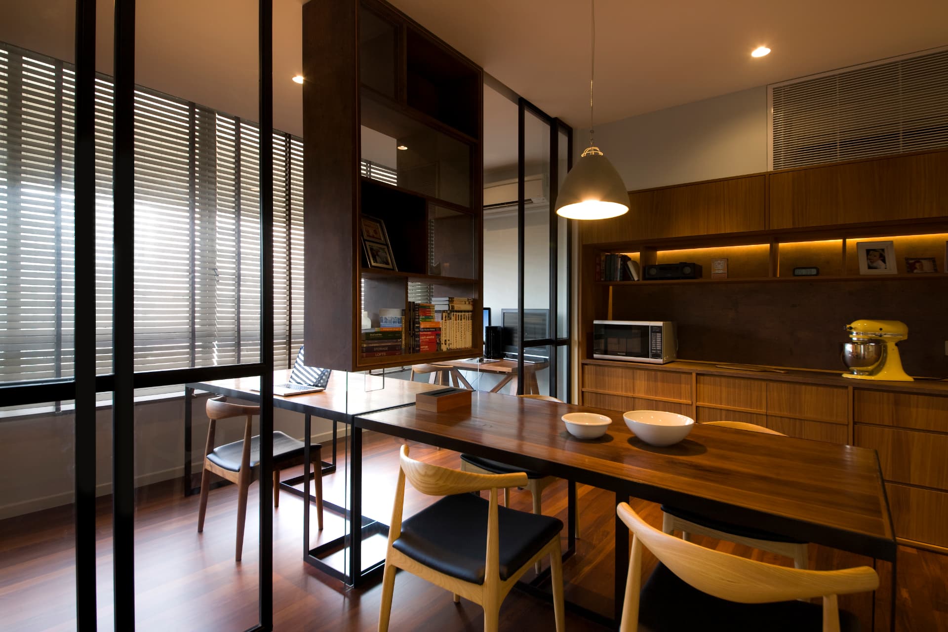 Warm timber dining area with glass partitions and integrated lighting